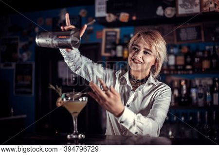 Pretty Girl Bartender Adds Ingredients To A Cocktail Behind Bar