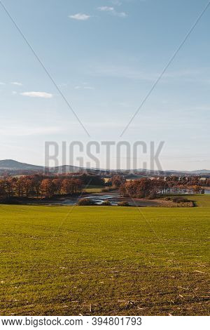 Czech Autumn Landscape. Dry Pond Dehtar With Meadow, Trees And Distant Hill At Day Time, Toned Photo