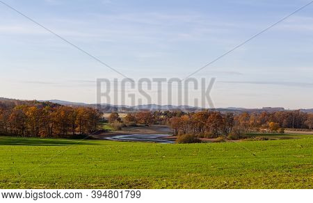 Czech Autumn Landscape. Dry Pond Dehtar With Meadow, Trees And Distant Hill At Day Time
