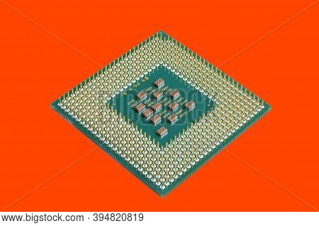 Photo Of A Cpu Chip Isolated On An Orange Background. Microprocessor, Central Processing Unit. Compu