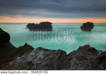 Picturesque Seascape. Amazing Landscape. Rock In The Ocean. Motion Waves. Silky Water. Long Exposure