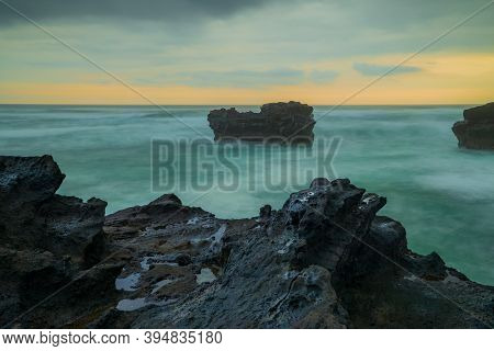 Picturesque Seascape. Amazing Landscape. Rock In The Ocean. Motion Waves. Silky Water. Long Exposure