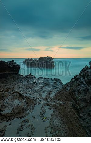 Picturesque Seascape. Amazing Landscape. Rock In The Ocean. Motion Waves. Silky Water. Long Exposure