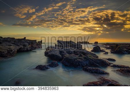 Beautiful Seascape. Long Exposure Rocky Beach During Low Tide. Panoramic Ocean View. Composition Of 