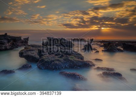 Beautiful Seascape. Long Exposure Rocky Beach During Low Tide. Panoramic Ocean View. Composition Of 