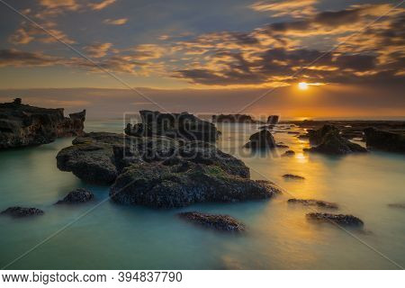 Beautiful Seascape. Long Exposure Rocky Beach During Low Tide. Panoramic Ocean View. Composition Of 