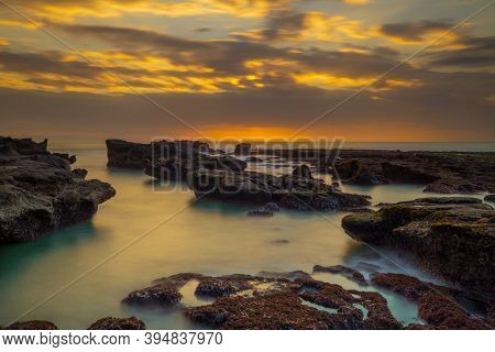 Beautiful Seascape. Long Exposure Rocky Beach During Low Tide. Panoramic Ocean View. Composition Of 