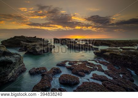 Beautiful Seascape. Long Exposure Rocky Beach During Low Tide. Panoramic Ocean View. Composition Of 
