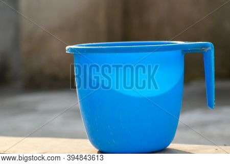 A Beautiful Blue Plastic Bath Mug With High Resolution