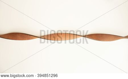 Leather Brown Strap On A White Background. Intertwined Strap.