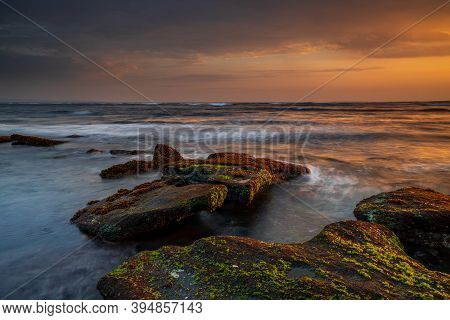 Beautiful Seascape. Beach With Stones Covered By Seaweeds. Low Tide. Composition Of Nature. Motion W