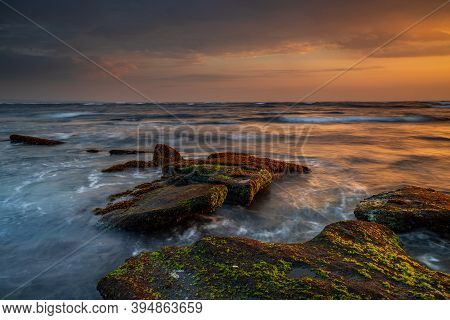 Beautiful Seascape. Beach With Stones Covered By Seaweeds. Low Tide. Composition Of Nature. Motion W