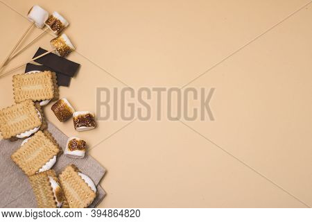 Freshly Toasted Smores With Marshmallow And Chocolate On Yellow Background Top View Copy Space Horiz