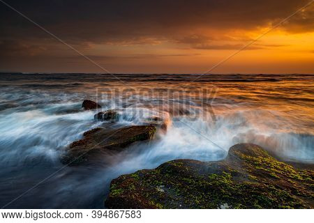 Beautiful Seascape. Beach With Stones Covered By Seaweeds. Low Tide. Composition Of Nature. Motion W