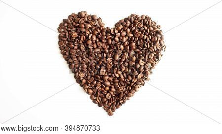 Coffee Beans Laid Out In The Shape Of A Heart On A White Background.
