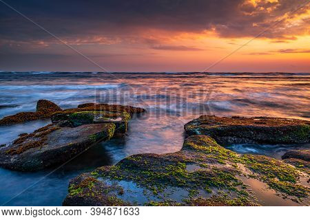 Beautiful Seascape. Beach With Stones Covered By Seaweeds. Low Tide. Composition Of Nature. Motion W