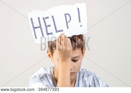 Sad Tired Frustrated Boy Holding Torn Paper Card With Word Help. Learning Difficulties, Kid Emotions
