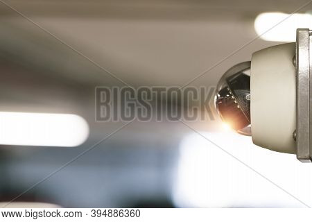 Modern Of Cctv Camera For Monitoring Surveillance And Security On The Wall With Car Park Background.