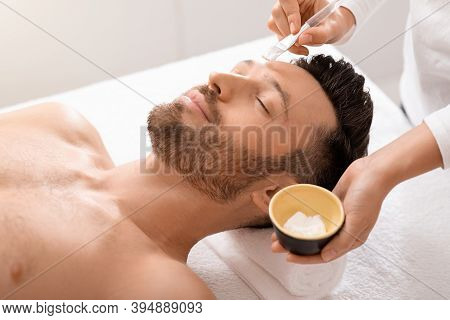 Relaxed Man Attending Cosmetologist Or Spa Salon, Enjoying Weekend. Bearded Middle Aged Man Getting 