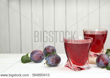 Delicious Plum Liquor And Ripe Fruits On Table Against White Background, Space For Text. Homemade St