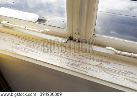 Old Wooden Window Sill With Cracked Peeling Paint And Durt, Needs Renovation And Repaired, Replaced