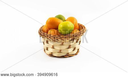 Small Wicker Basket With Kumquats And Limequats, Exotic Citrus Fruits In Winter On White Isolated Ba