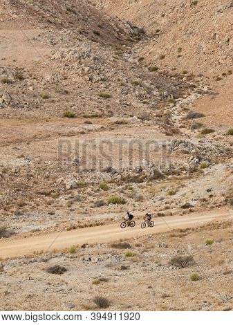 Circa, September 2020. Two Cyclists Go For An Off-road Ride On A Mountain Path In Oman. High Resolut