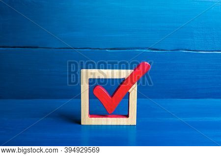 Red Voting Check Mark On A Blue Background. Voting Concept For Democratic Elections. Make The Best C