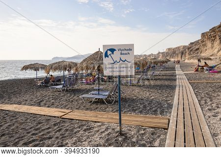 Santorini, Greece - September 16, 2020: Paid Sun Loungers At The Vlychada Beach On The Southern Side