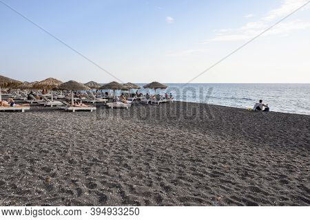 Santorini, Greece - September 16, 2020: Vlychada Beach Covered With Dark Grey Sand. Southern Side Of
