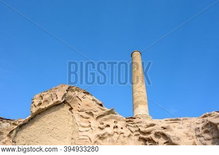 A Large Chimney And Bright Cliffs Formed By A Volcano At Vlychada Beach On The Southern Side Of Sant
