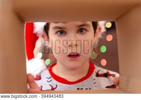 The Shock Of Emotion In A Boy In A New Years Jumper And A Hat Of Santa Clau