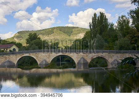 Beautiful Old Bridge Over A Calm River On A Sunny Day