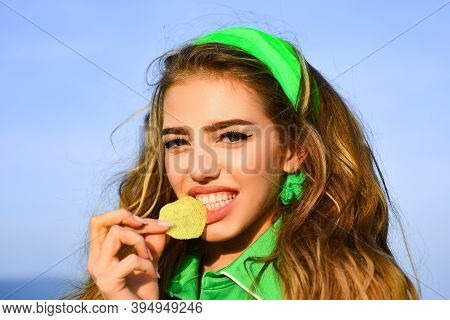Smiling Woman Eat Potato Chips. Young Woman Biting Piece Of Potato Chips With Teeth. Tasty Delicious
