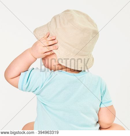 Baby wearing beige bucket hat