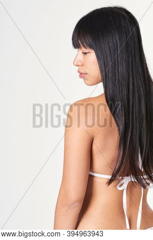 Asian woman in white bikini