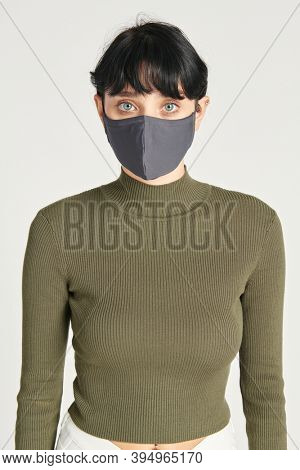 Face mask mockup on a women in a green turtleneck top