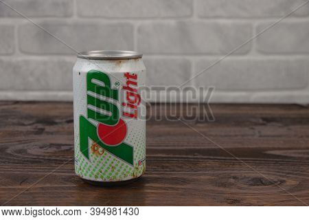 An Old Aluminium Can Of 7up Soft Drink Against The Brick Wall