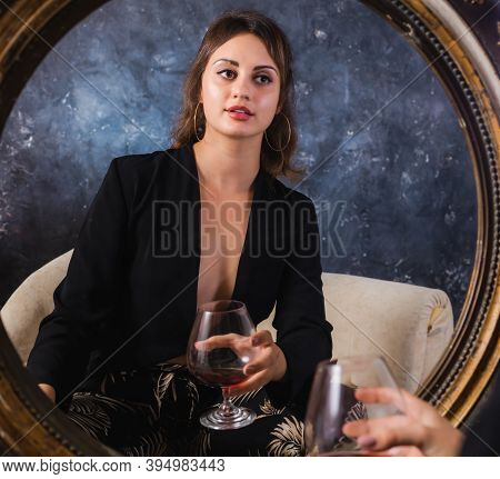 Beautiful Young Lady In Black Jacket Sitting Afront Of The Vintage Mirror With Glass Of Wine Studio 