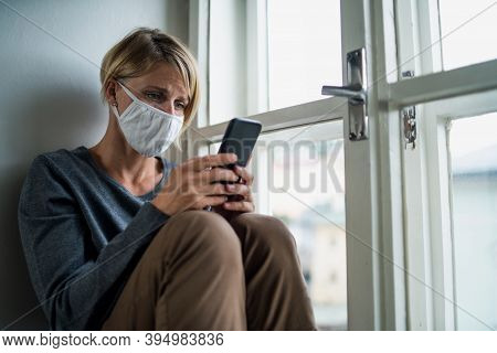 Stressed Woman With Smartphone Indoors At Home, Mental Health And Coronavirus Concept.