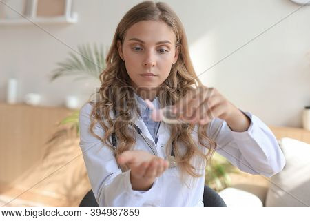 Medical Specialist Disinfecting Hands With Hand Rub Antiseptic.