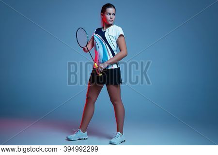 Beautiful Handicap Woman Practicing In Badminton Isolated On Blue Background In Neon Light. Lifestyl