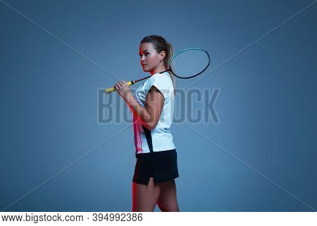 Beautiful Handicap Woman Practicing In Badminton Isolated On Blue Background In Neon Light. Lifestyl