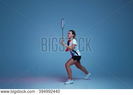 Beautiful Handicap Woman Practicing In Badminton Isolated On Blue Background In Neon Light. Lifestyl