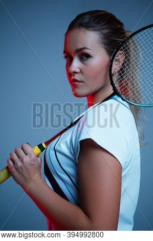 Strong. Beautiful Handicap Woman Practicing In Badminton Isolated On Blue Background In Neon Light. 