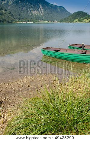 Lake In Tirol With Wooden Boats