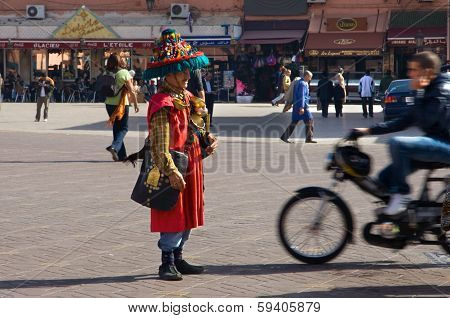 A Motorbiker Avoids A Motionless Water Seller