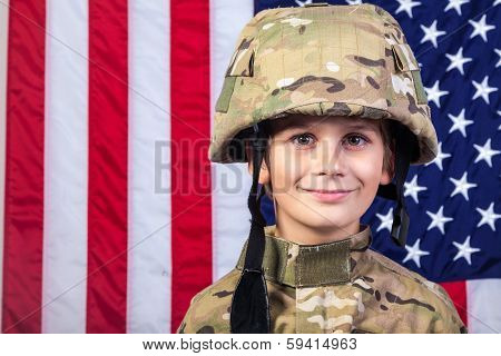 Young Boy Dressed Like A Soldier With American Flag