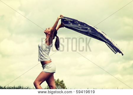Girl with voile against cloudy sky