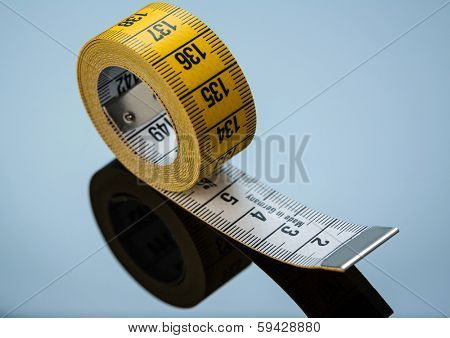 yellow tape measure, symbolic photo for diet control and precision